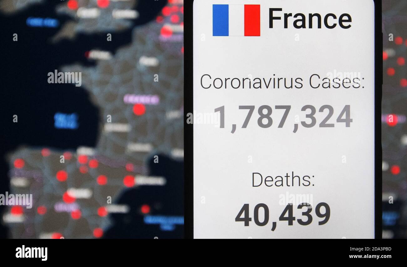 In this photo illustration, the statistics of Covid-19 coronavirus spread in France by worldometers website seen displayed on a smartphone with a background of a map by the Center for Systems Science and Engineering (CSSE) at Johns Hopkins University (JHU) showing the Covid-19 coronavirus global spread on a computer screen.The Covid-19 global cases pass 50 million and 10 million in the U.S., according to internet online trackers of the coronavirus spread. Stock Photo