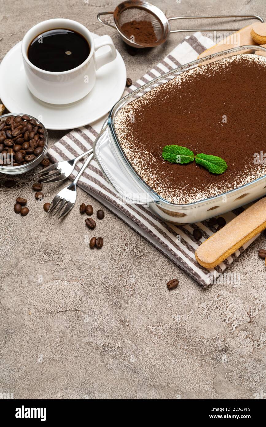 Traditional Italian Tiramisu Dessert In Glass Baking Dish Savoiardi Cookies And Cup Of Fresh Hot Espresso Coffee On Concrete Background Stock Photo Alamy