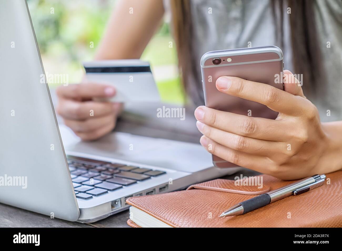 A woman shopping on mobile with credit card Stock Photo