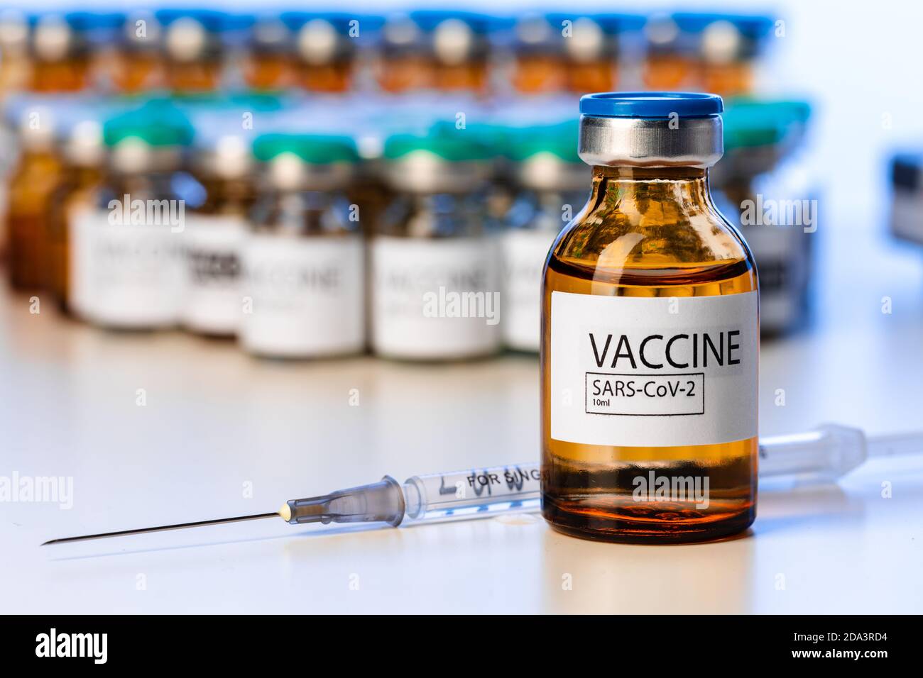 Covid-19 vaccine bottle with a syringe on lab table Stock Photo - Alamy