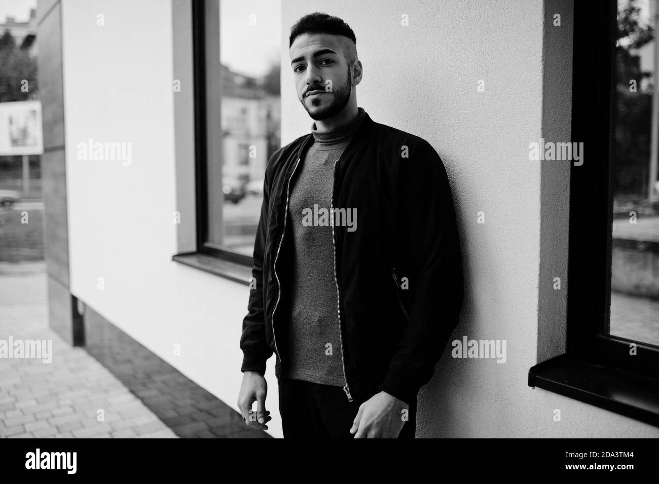 Portrait of stylish arab beard man wear grey turtleneck and black jaket. Arabian model guy. Stock Photo