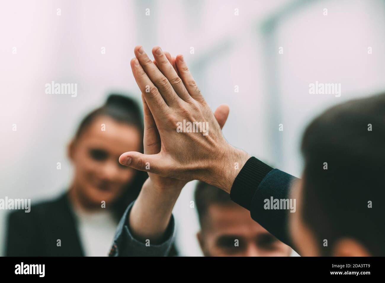 close up. young employees giving each other a high five Stock Photo - Alamy