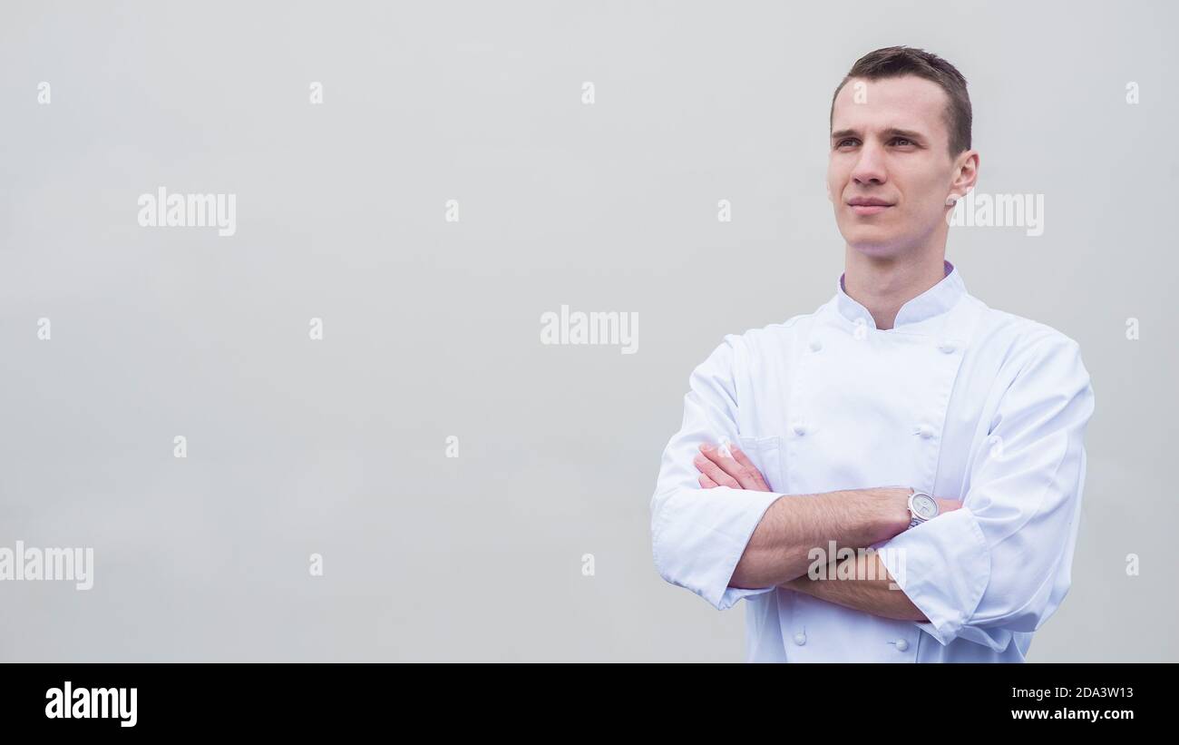 Portrait of young master chef on blank background Stock Photo - Alamy