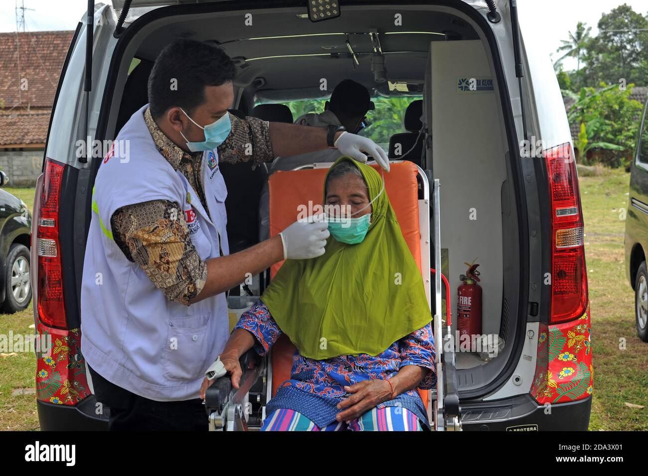 Yogyakarta, Indonesia. 9th Nov, 2020. A health worker checks the health condition of an elderly woman at temporary shelter for villagers living near Mount Merapi at Glagaharjo village in Cangkringan, Yogyakarta, Indonesia, Nov. 9, 2020. Merapi is the most active volcano in Indonesia. The status of the 2,968-m high volcano was declared as the second-highest alert level, which means that its eruption can occur at any time. Credit: Supriyanto/Xinhua/Alamy Live News Stock Photo