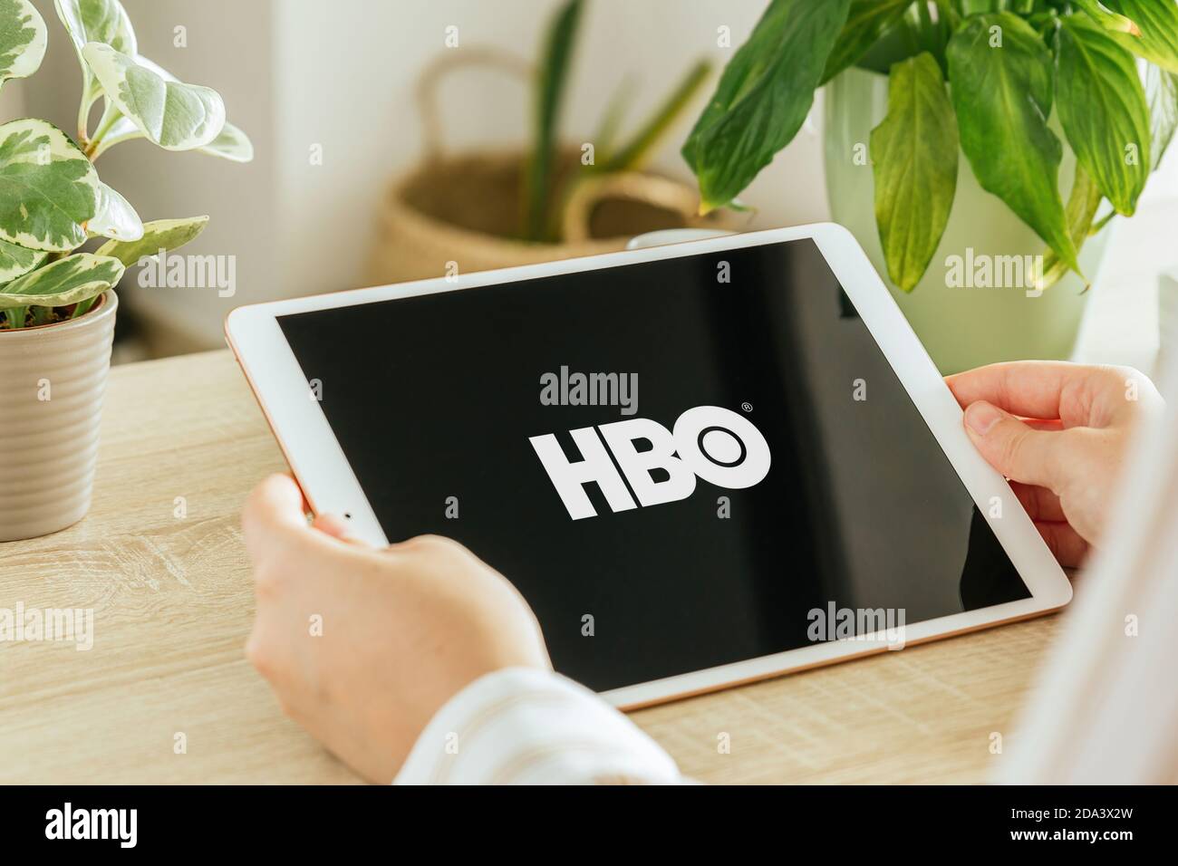 VALENCIA, SPAIN - OCTOBER, 2020: HBO app on a tablet screen. Young Girl is watching On demand TV shows, Documentary, Series and Movies via tablet in t Stock Photo