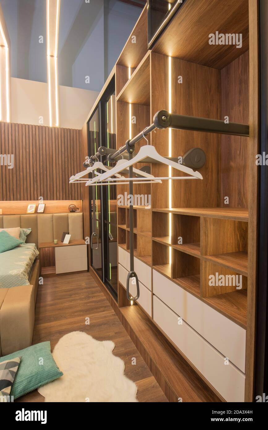 Interior design decor furnishing of luxury show home bedroom showing wooden wardrobe closet furniture Stock Photo