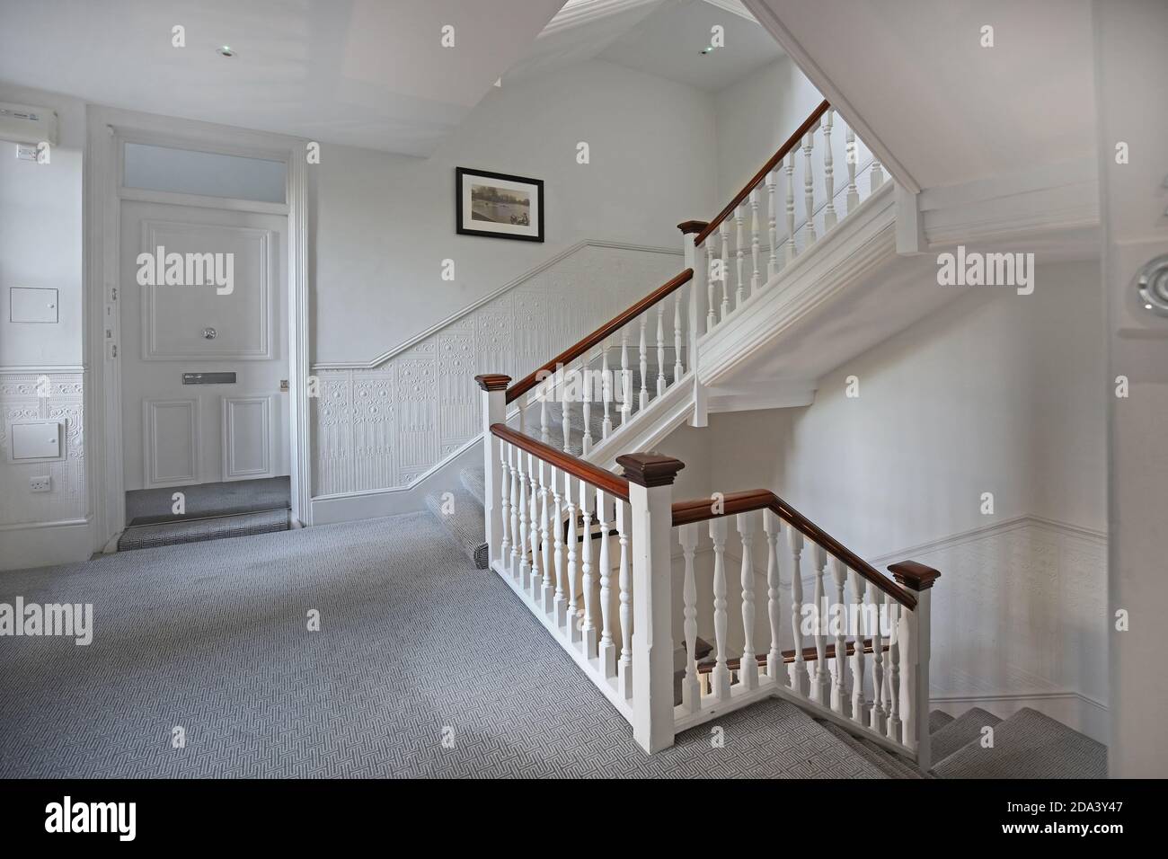 Newly refurbished landing in York Mansions, a Victorian block of luxury flats in Battersea, London, UK. Shows traditional timber stairs & ballustrade. Stock Photo