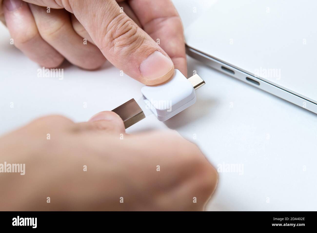 Man uses modern technologies to store memory and digital data. type-c Stock Photo