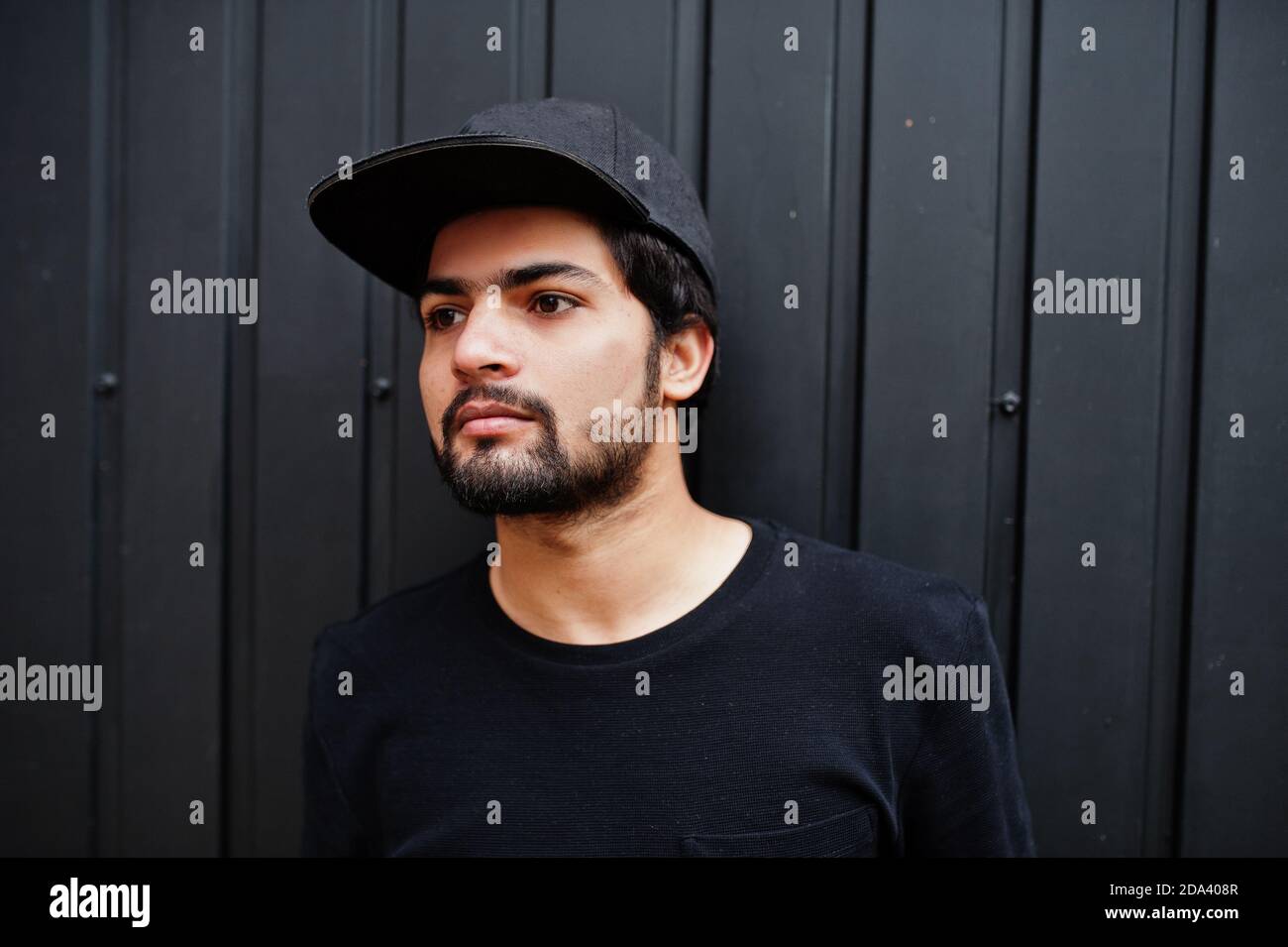 Urban young hipster indian man wear all in black. Cool south asian guy in full  cap Stock Photo - Alamy