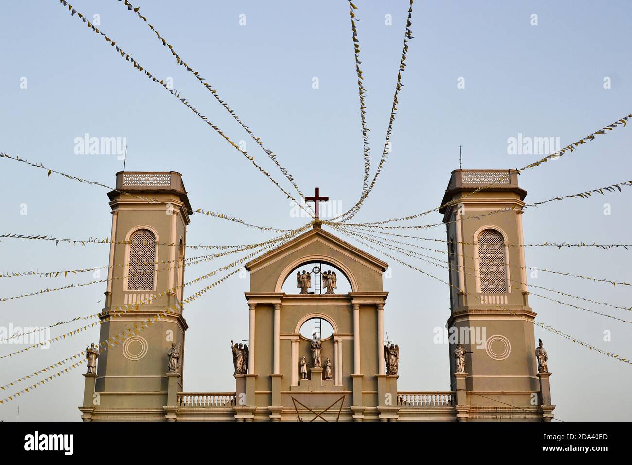 View of Milagres Church or Church of Our Lady of Miracles built in 17 century. British colonial building with two towers and catholic cross and statue Stock Photo