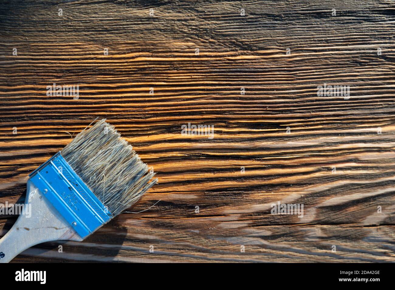 Brush and stain on wood board. Wood texture and paintbrush . housework