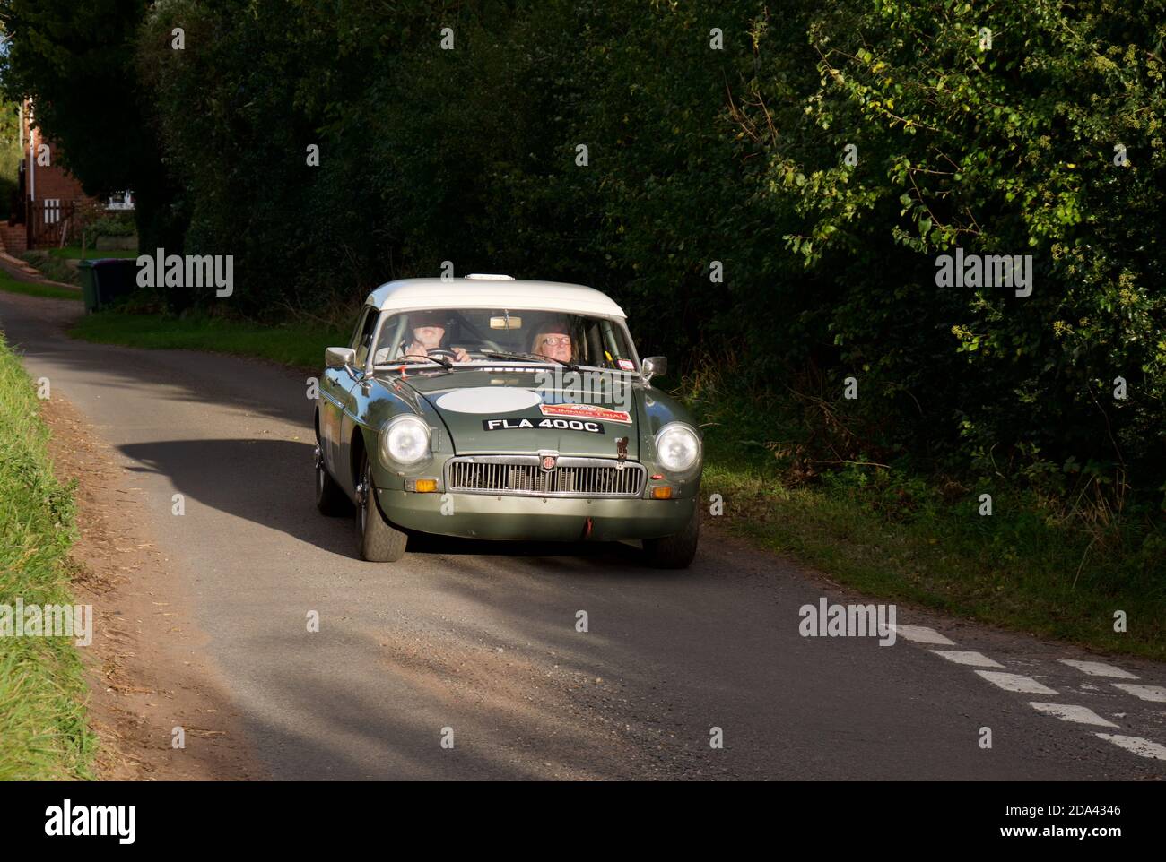 Rally Driving into the evening sun in a MGB Stock Photo
