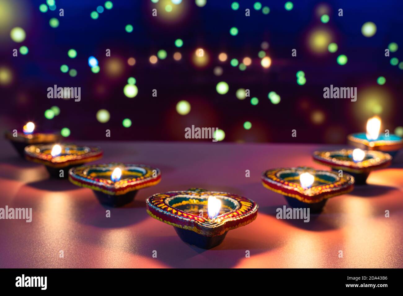 Indian festival Diwali, Diya oil lamps lit on colorful rangoli ...