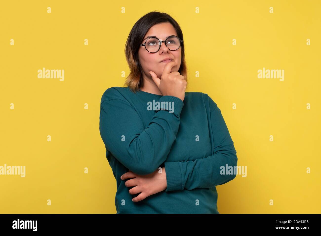 Caucasian woman with glasses having thoughtful look. Stock Photo