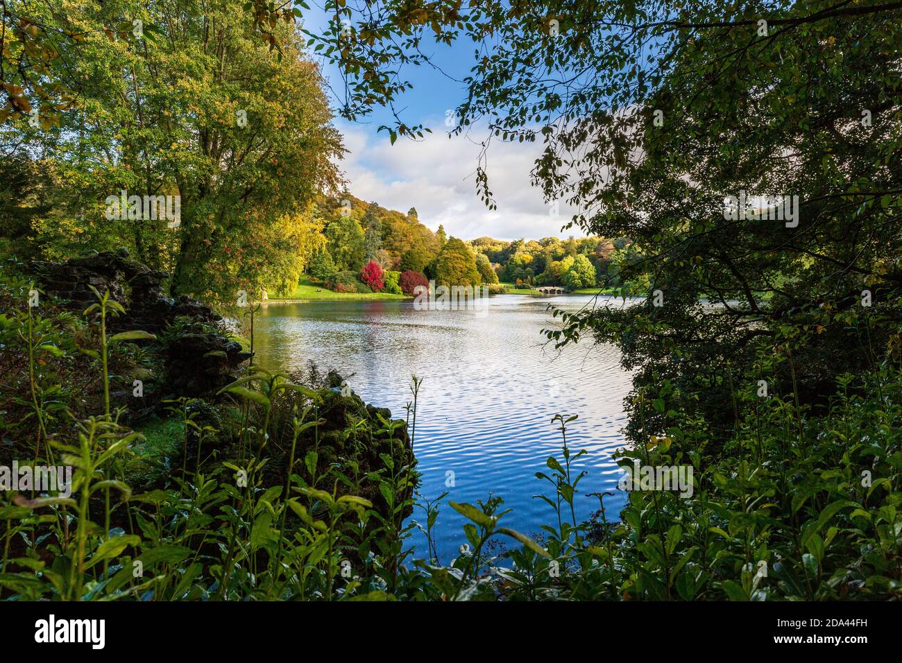 Autumn colour across the lake at Stourhead in Wiltshire, England Stock Photo