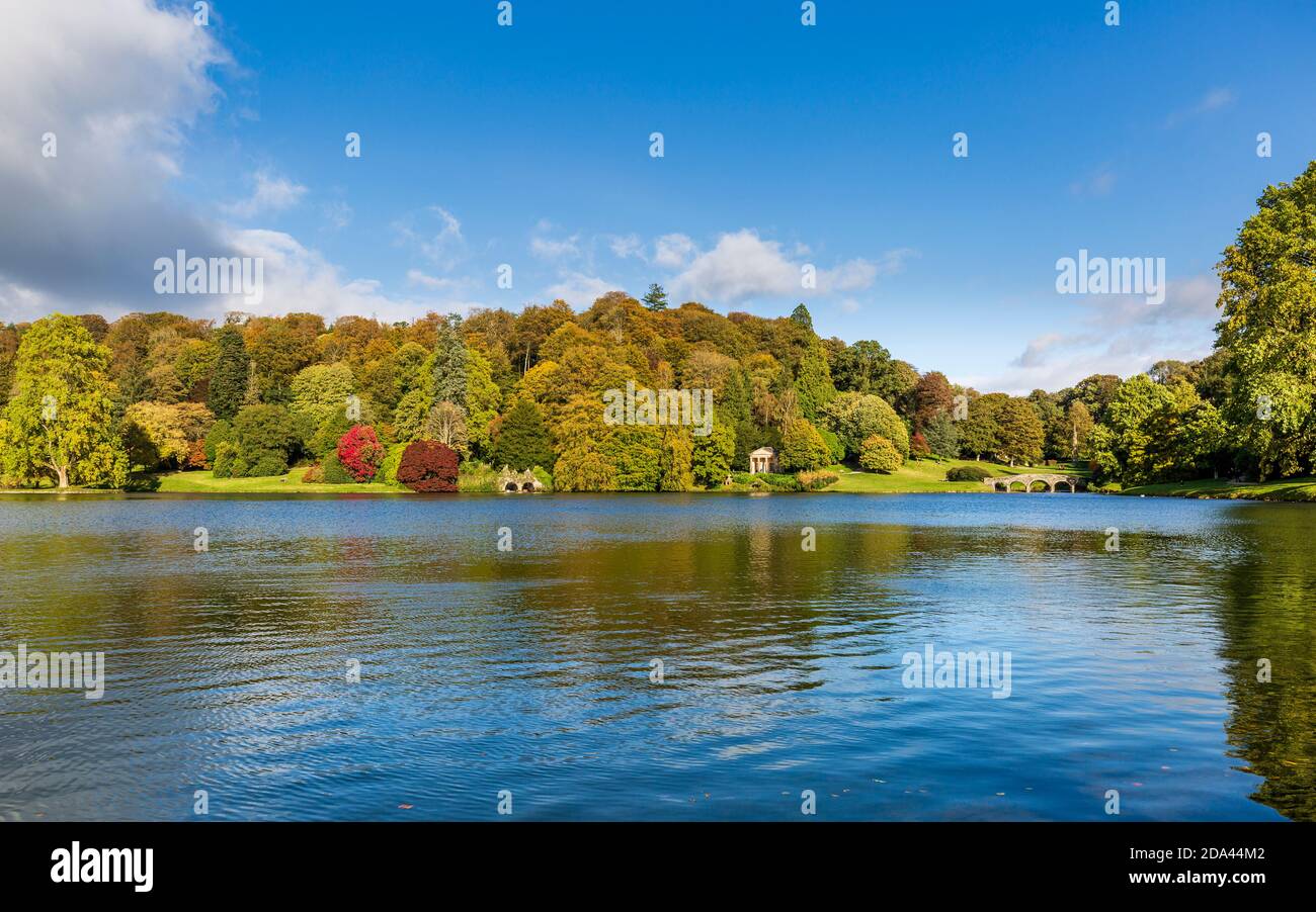 Autumn colour across the lake at Stourhead in Wiltshire, England Stock Photo