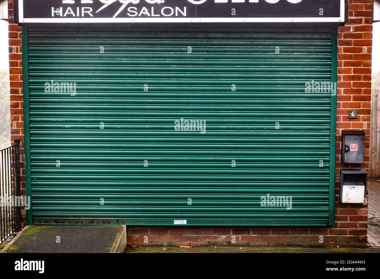 Hair salon closed down with closed shutters Stock Photo Alamy