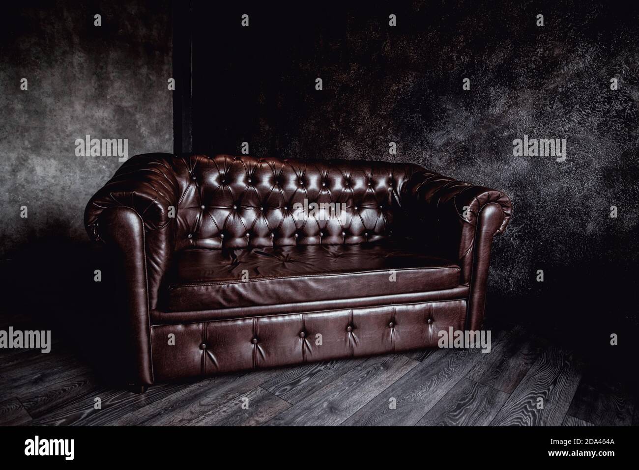 picture Brown Leather Couch Grey Walls https www alamy com big brown leather sofa in a dark room gray walls concrete image384867290 html