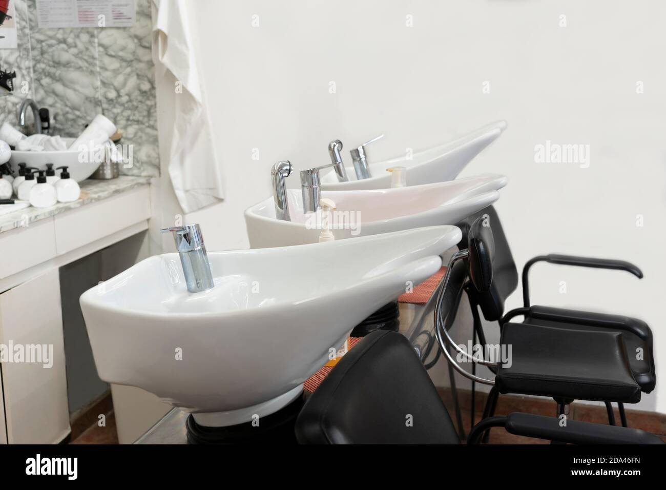 Barber shop, hairdressing salon interior.Hair wash basins chairs. Copy space text. Stock Photo