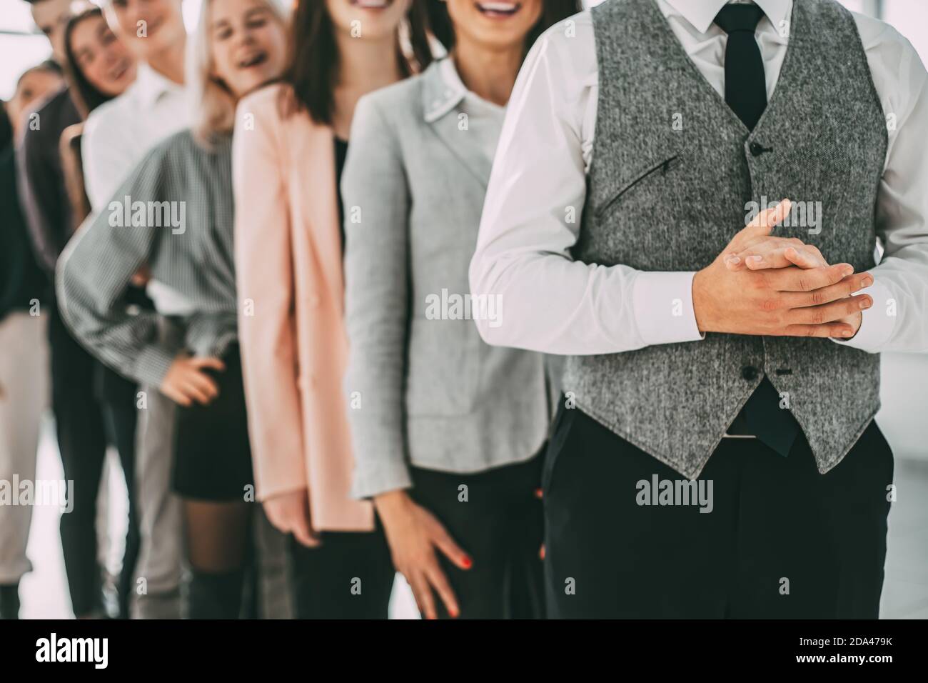 group of diverse young people standing in a long queue Stock Photo