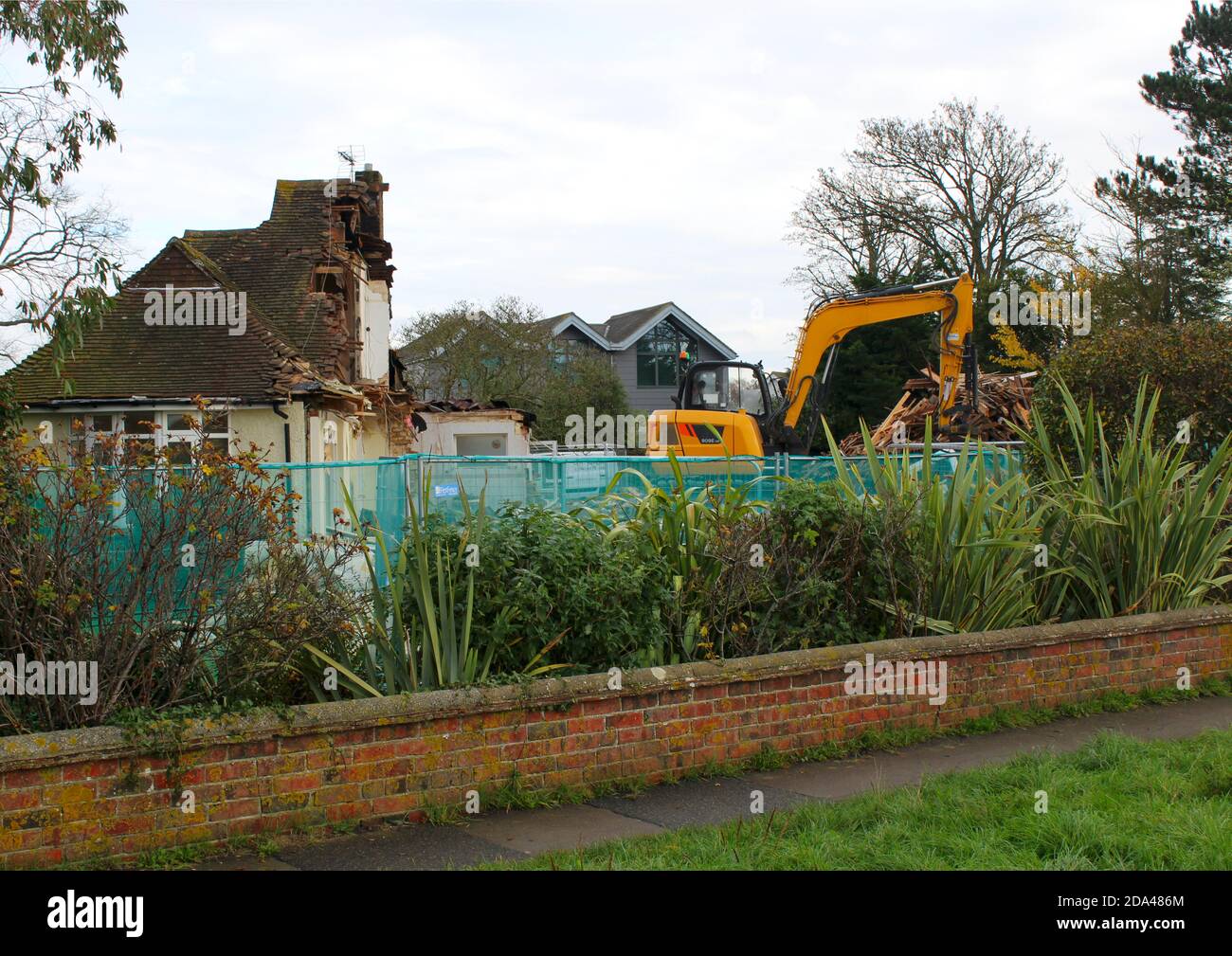 Heavy machinery demolishes old house on the waterfront at Chichester ...