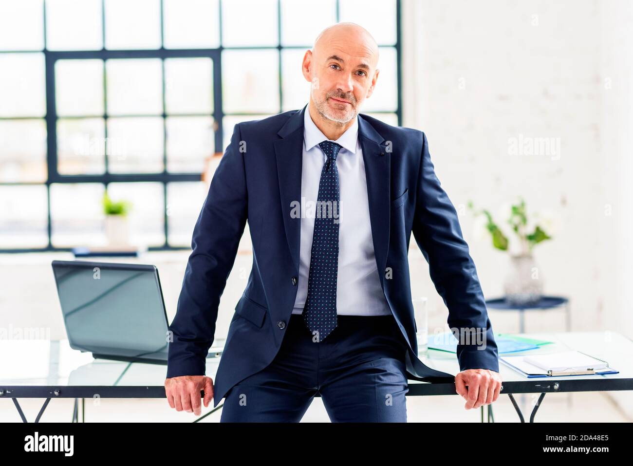 Shot of smiling senior businessman wearing suit and tie while standing ...