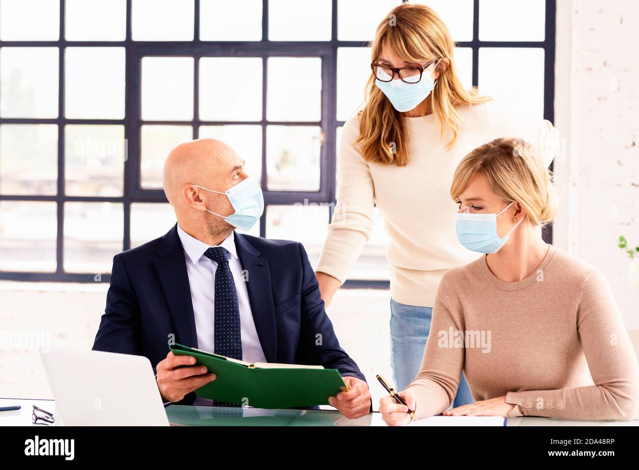 Group of business people wearing face mask while working together in ...
