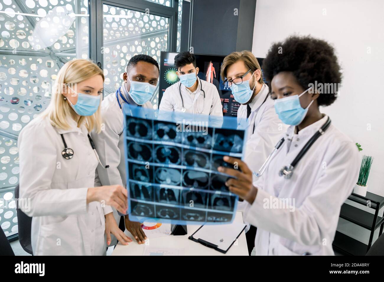 Team of multiethnic doctors or scientists, wearing protective medical