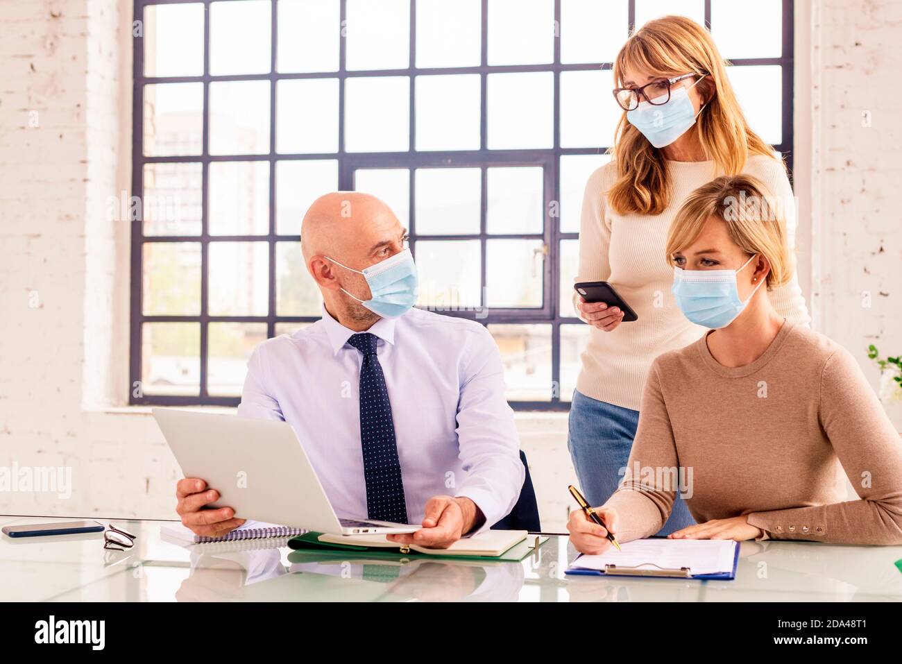 Group of business people wearing face mask while working together in ...