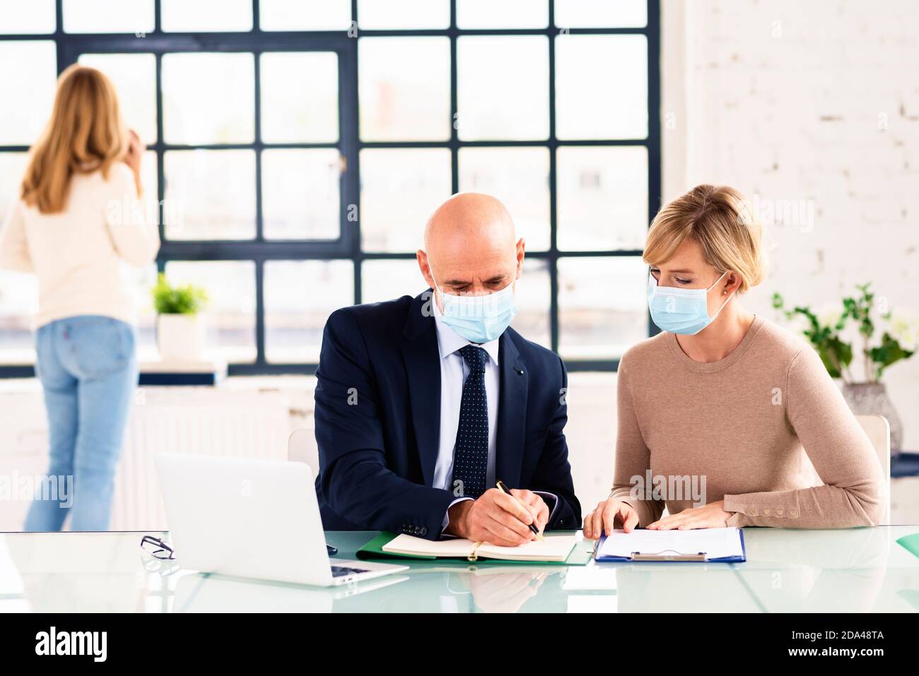 Group of business people wearing face mask while working together in ...