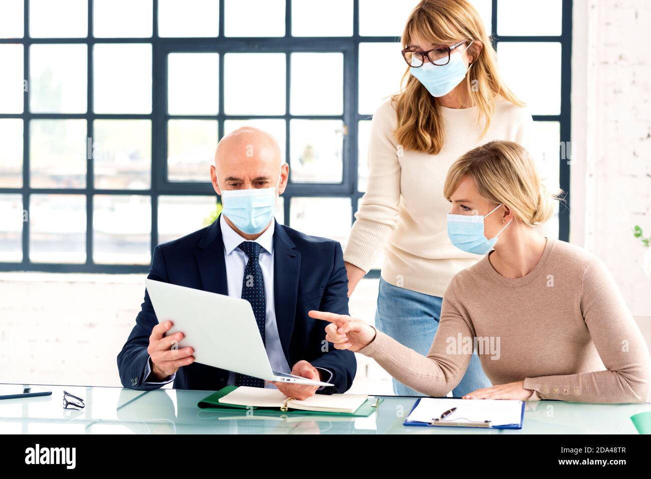 Group of business people wearing face mask while working together in ...