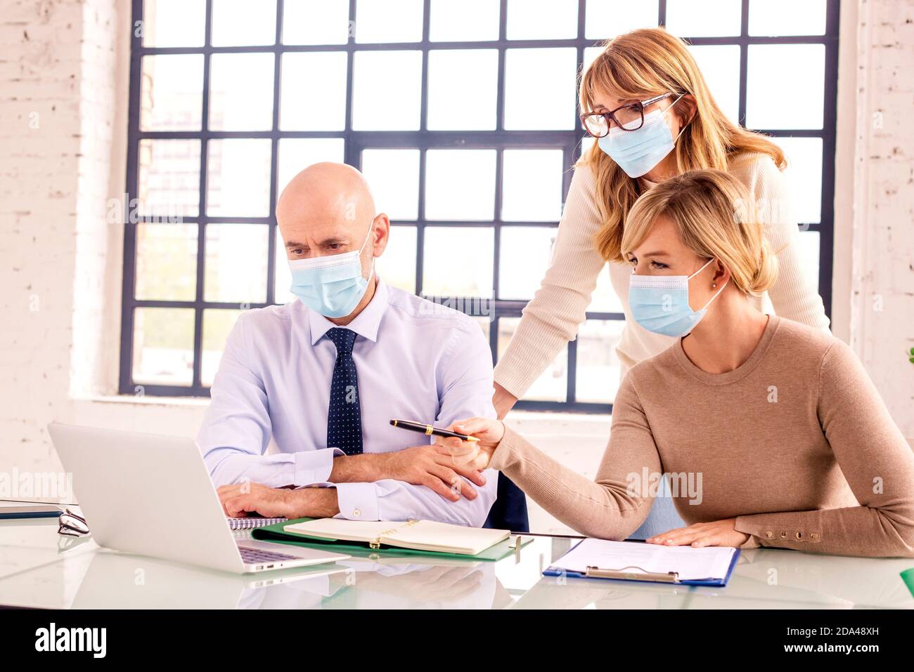 Group of business people wearing face mask while working together in ...