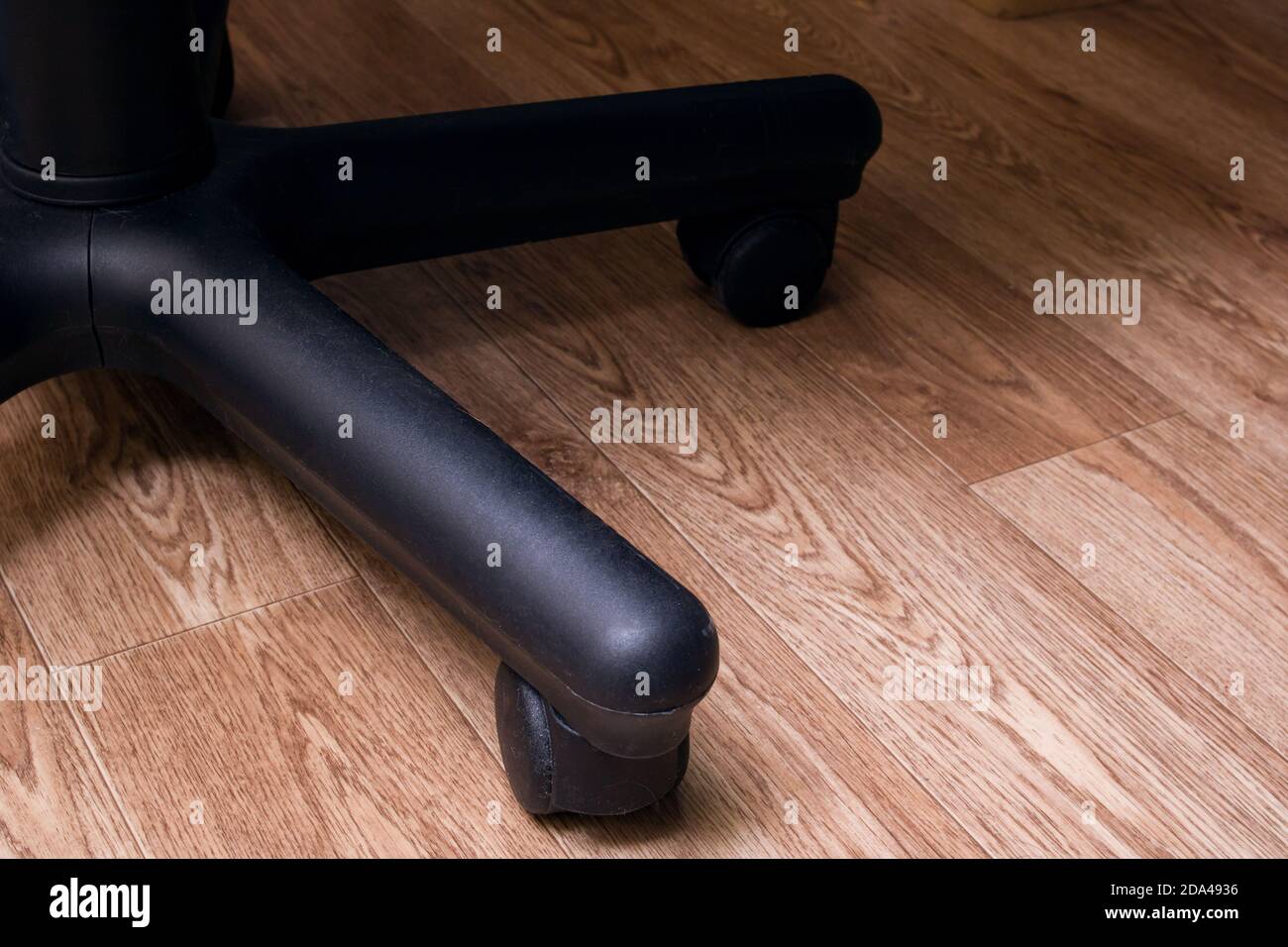 Office chair wheels on a wooden floor Stock Photo Alamy