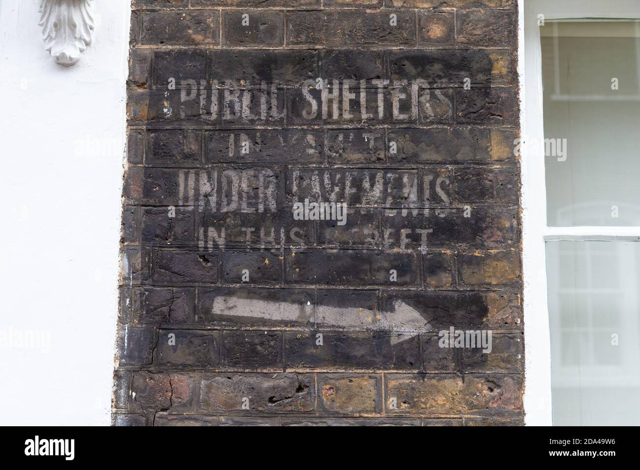 Public shelters in vault under pavements in this street, ghost sign on wall, london street, uk Stock Photo