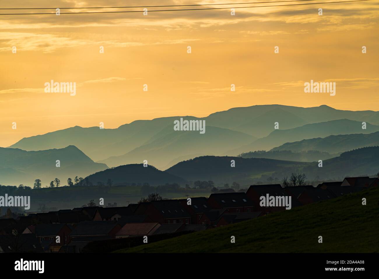 Colourful skies over Penrith and the hazy lake district fells on an autumn afternoon Stock Photo