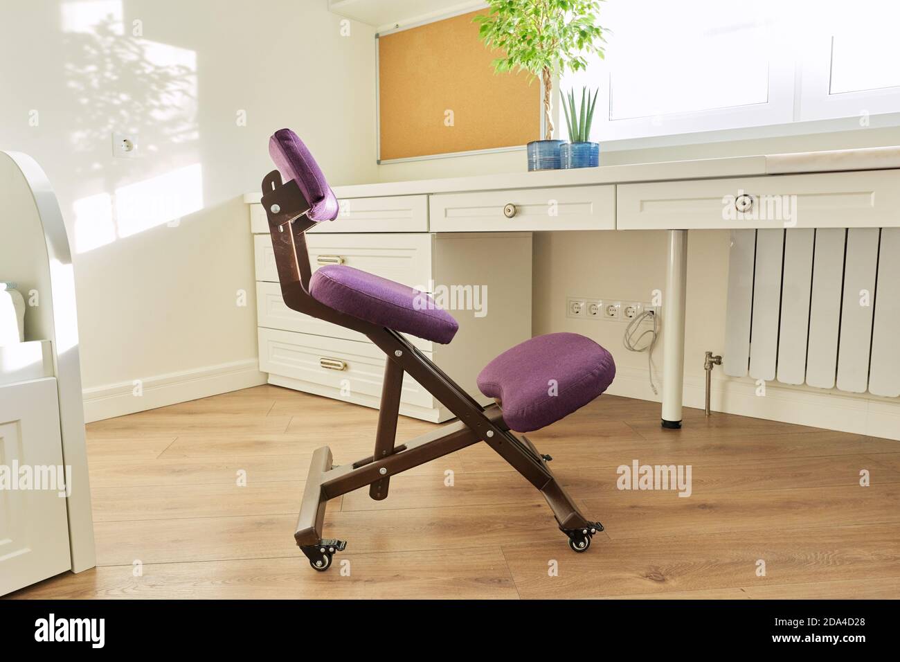 Orthopedic ergonomic kneeling chair in the interior of children's room