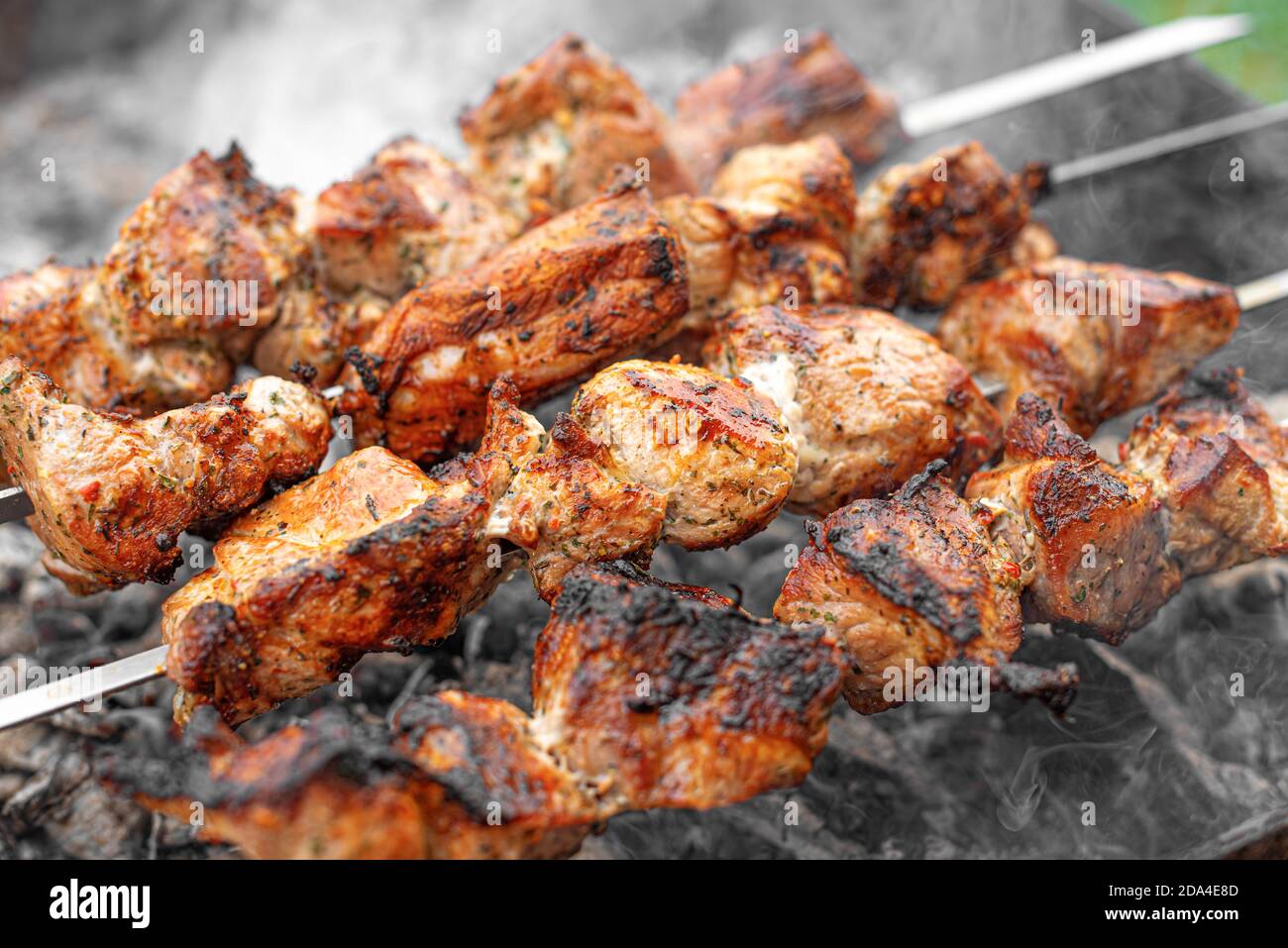 The barbecue is grilled on the grill. Meat or shish kebab on the fire Stock Photo