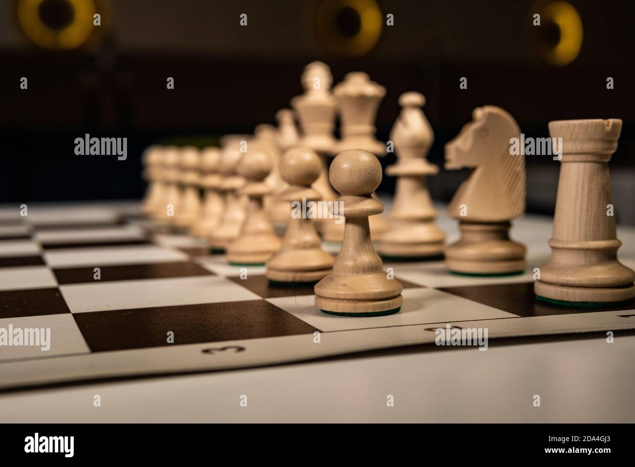 Play old chess tree on a platform in a white cage, black pieces and rooks, queens and kings, horses table in the dark, stylish for advertising design. Stock Photo