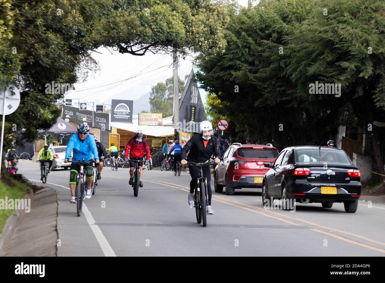 LA CALERA COLOMBIA - OCTOBER, 2020: Group of amateur cyclists arriving to the well known Alto de Patios on the road between Bogota and La Calera on th Stock Photo