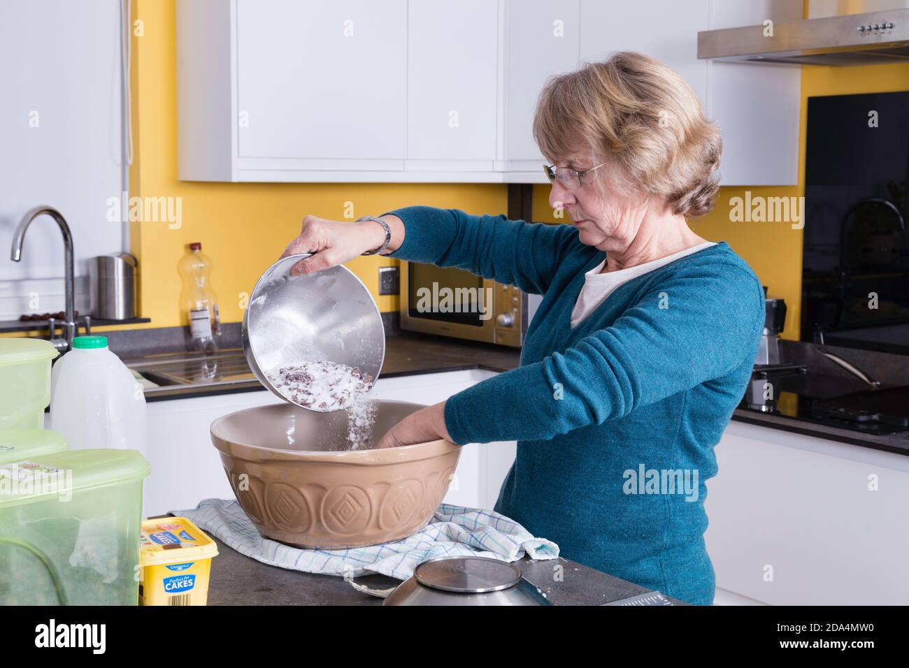 Lady in her late 60s baking Welsh cakes in her kitchen Stock Photo