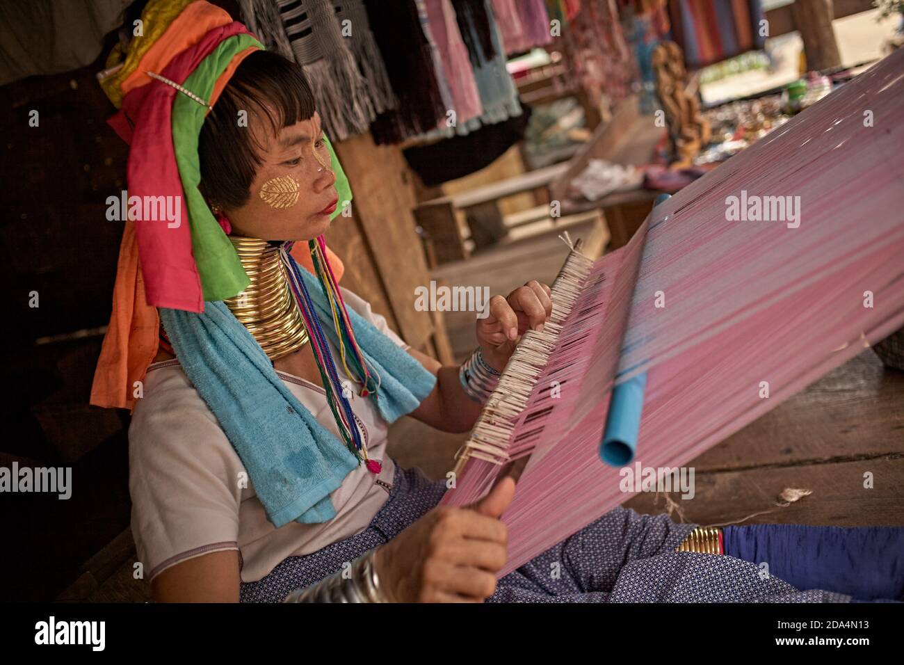 Mae Hong Son, Thailand, March 2012. Karen woman working in her village. These people are known as long-necked women because of the metal spiral they w Stock Photo