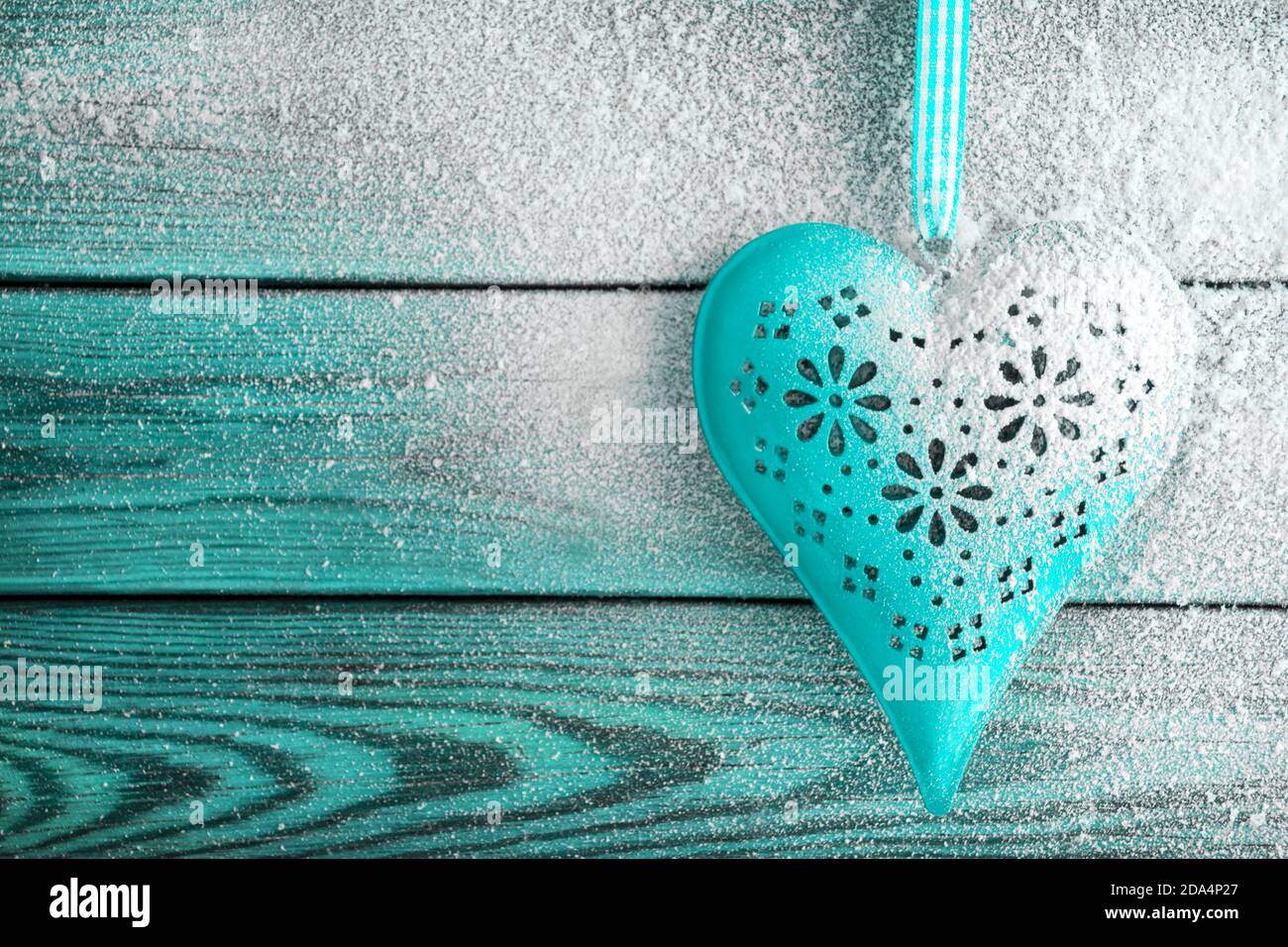 Heart and snow against wooden background Stock Photo