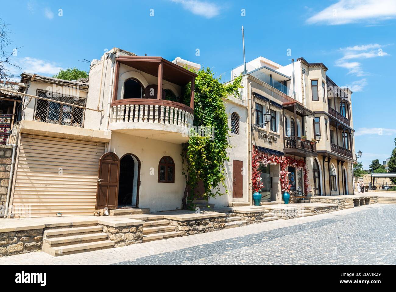 Baku, Azerbaijan – August 5, 2020. Historic building housing commercial and residential properties on Zeynalli street in the Icheri Sheher old city of Stock Photo