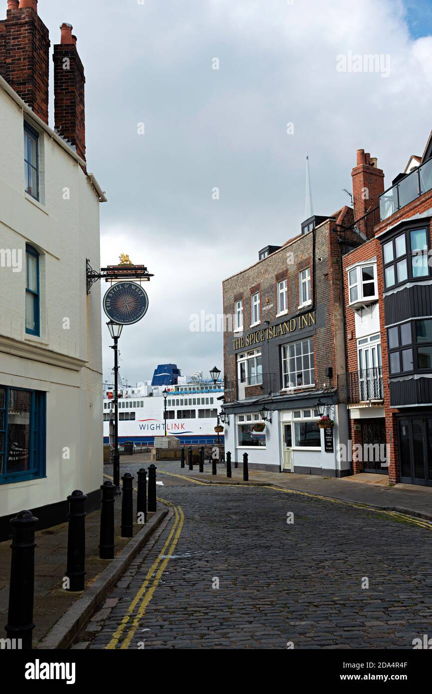 The Spice Island Inn and historic houses with the Wightlink ferry passing at the end of the road in Bath Square,Old Portsmouth, Hampshire, England, UK Stock Photo