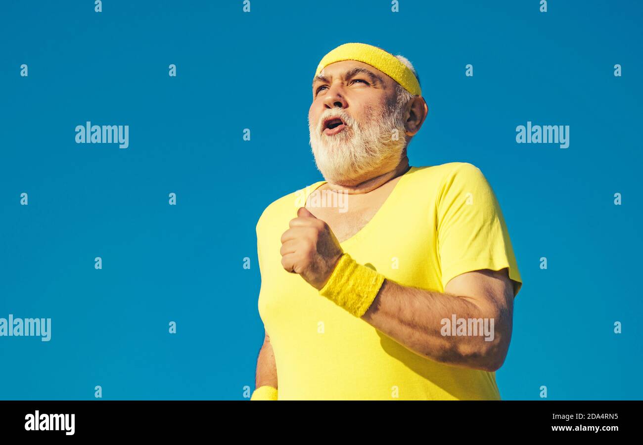 Healthcare cheerful lifestyle. Funny sporty old sportsman finished his