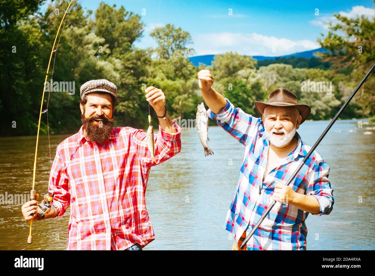 Fishing became a popular recreational activity. Fishing. Generations ages:  grandfather and father. Grandfather and boy fishing together Stock Photo -  Alamy