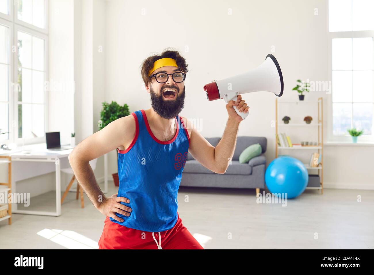 Funny fitness geek with megaphone shouting about amazing sale at the sports store Stock Photo