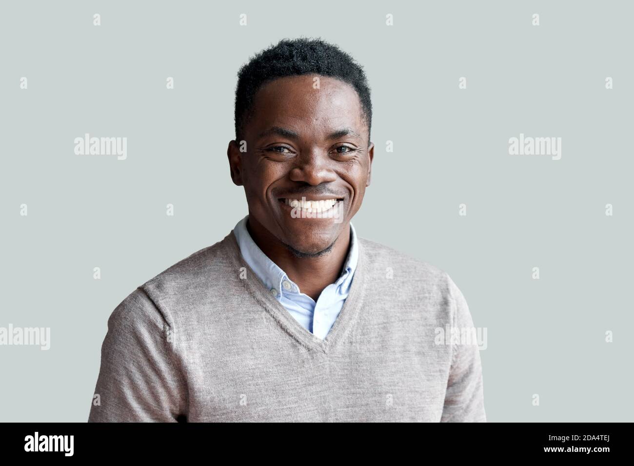 Smiling young african man looking at camera standing at home, headshot portrait. Stock Photo