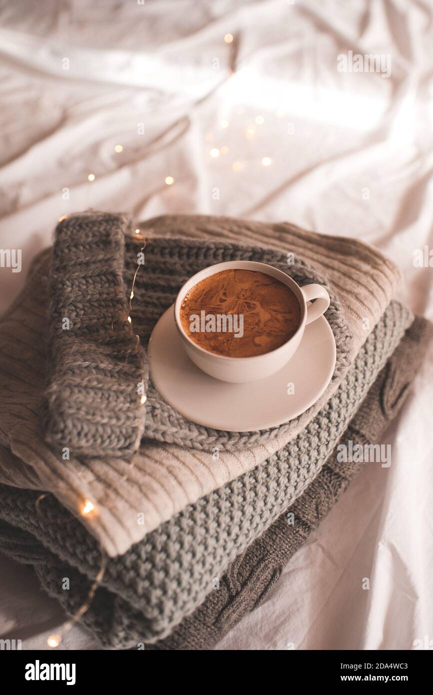 Cup of coffee staying on knitwear close up. Winter holiday season ...