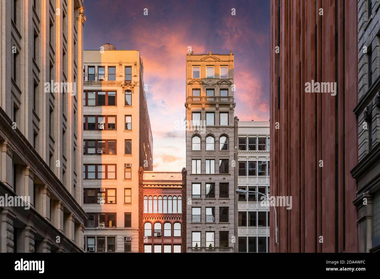 Colorful sunset sky above the historic buildings along Broadway in New ...